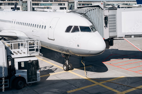 Modern plane with jet bridge on airfield