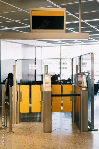 Gates and monitor in airport terminal photo