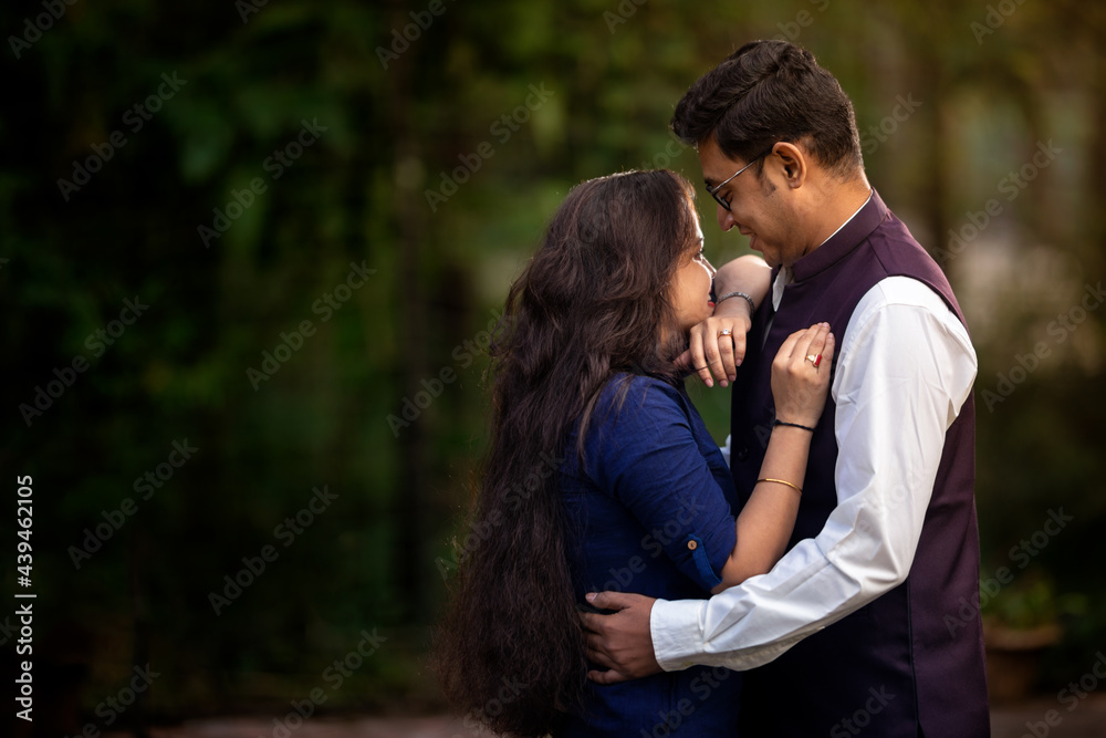 Happy attractive young couple hugging in forest Happy attractive young couple hugging in forest