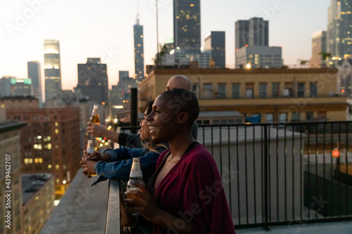 Friends Watch the Sunset and Drink On A Rooftop photo