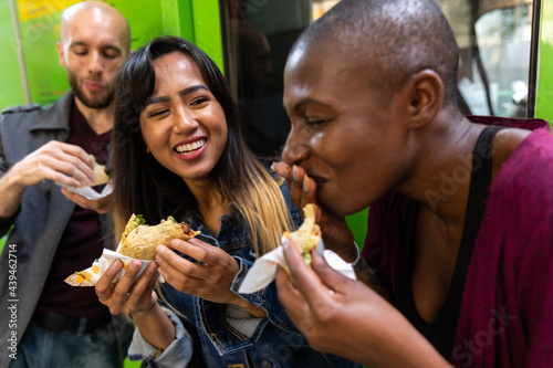 Woman Eats Taco With Friends photo