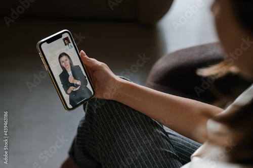 Crop woman watching online friend using sign language