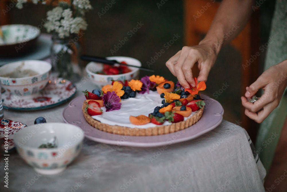 Woman Decorating a Cake with Flowers Woman Decorating a Cake with Flowers