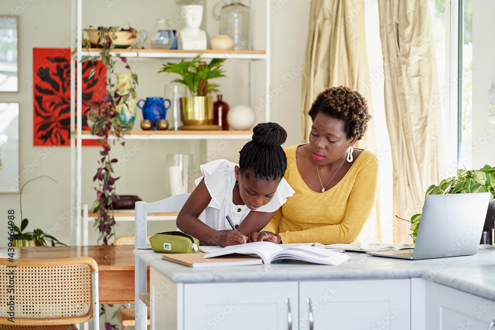 daughter learning at home with mom