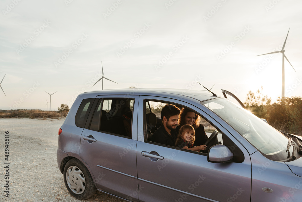 A young family with little daughter traveling by car. A young family with little daughter traveling by car.