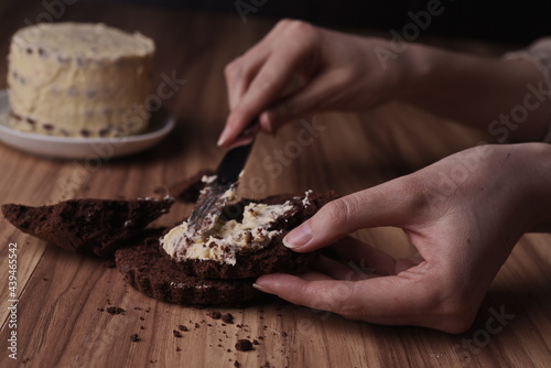 Spread the buttercream on the brownie slices to form the cake.