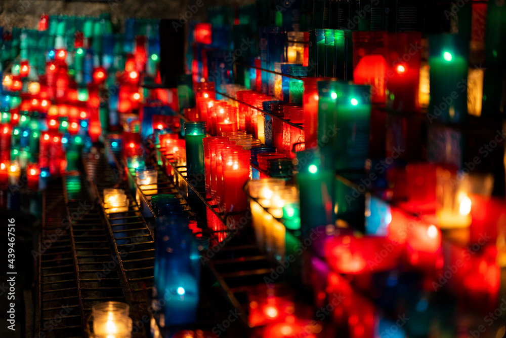 Arrangement of colorful lit candles in the dark Arrangement of colorful lit candles in the dark