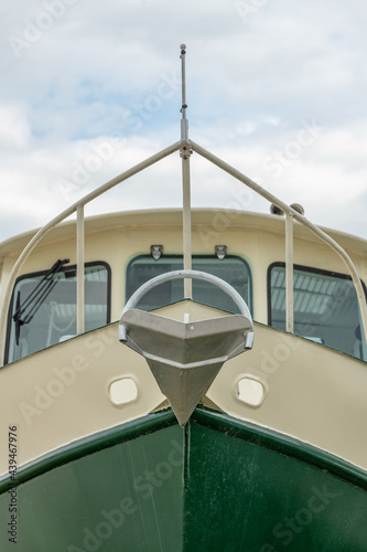 Bow of a Steel Boat Green and Yellow with mounted anchor © Roxane Bay
