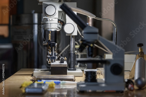 Illuminated microscope on desk in apiary