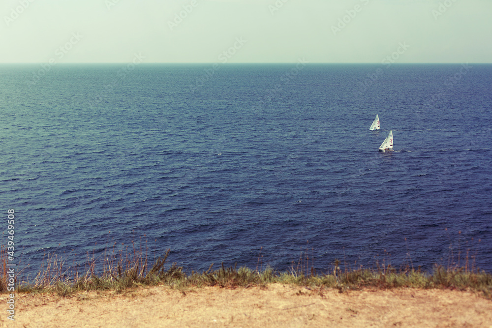 RUSSIA, ANAPA - AUGUST 23, 2016: Two sailing boats in the Black Sea near Anapa town. Russia, Black Sea, Krasnodar region, Anapa. RUSSIA, ANAPA - AUGUST 23, 2016: Two sailing boats in the Black Sea near Anapa town. Russia, Black Sea, Krasnodar region, Anapa.