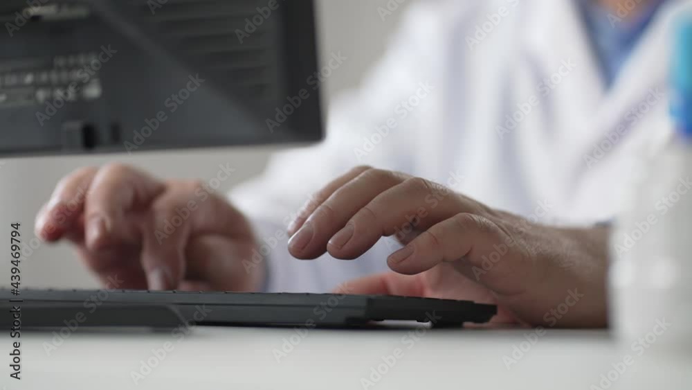 Close up of Caucasian man doctor hands tapping and typing on keyboard sitting in hospital office working at workplace. Healthcare worker fingers texting on computer. Clinic concept Close up of Caucasian man doctor hands tapping and typing on keyboard sitting in hospital office working at workplace. Healthcare worker fingers texting on computer. Clinic concept