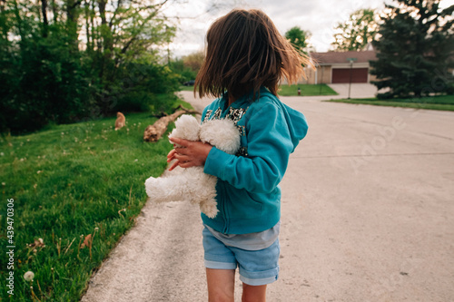 Young girl turned around looking at cat.  photo