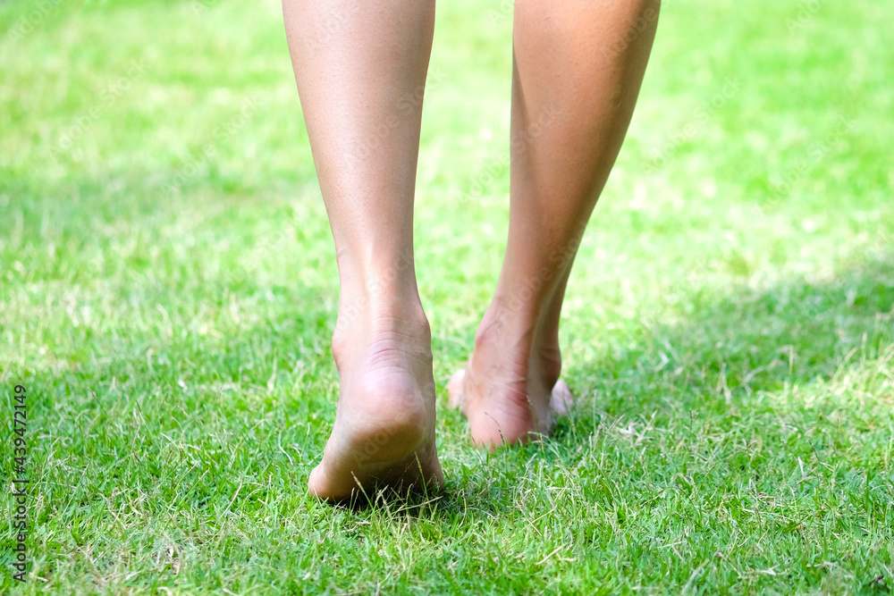 Leg of woman is on walk down the grass to exercise in the morning. Health and Relaxation Concepts