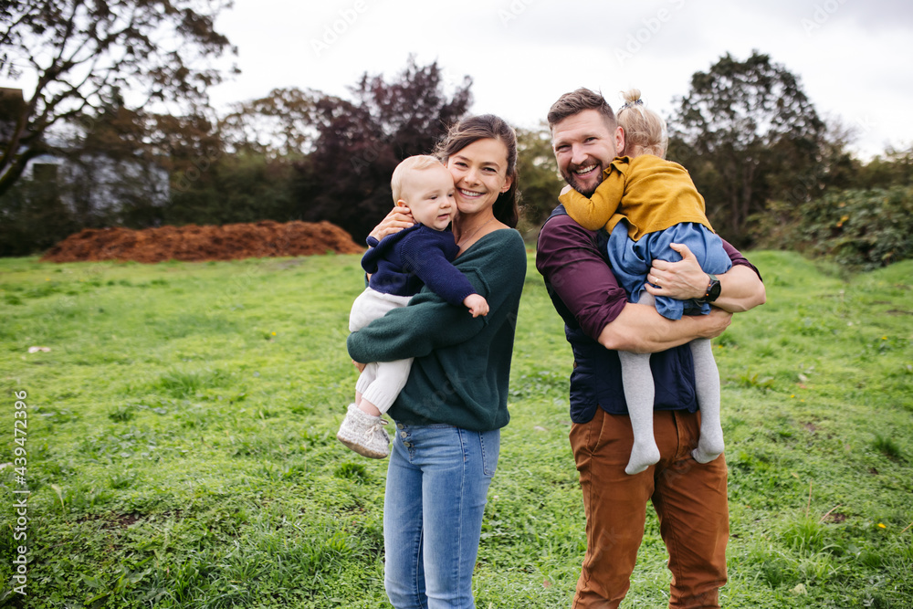 Young stylish family looking at the camera and smiling together Young stylish family looking at the camera and smiling together