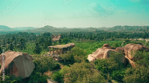 exotic landscape with temple ruins in rocks and green mountains