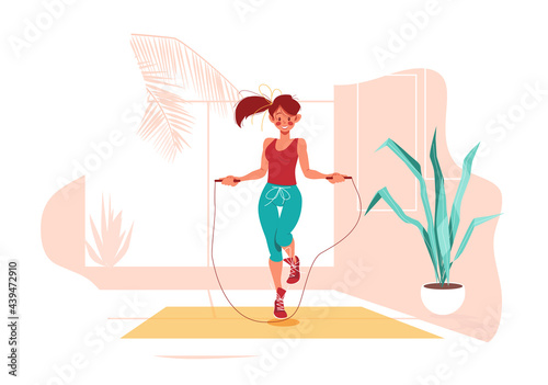 Fitness at home. Girl jumps on jump rope in room