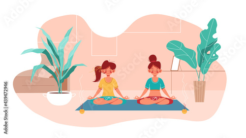 Fitness at home. Two girl do yoga in lotus pose