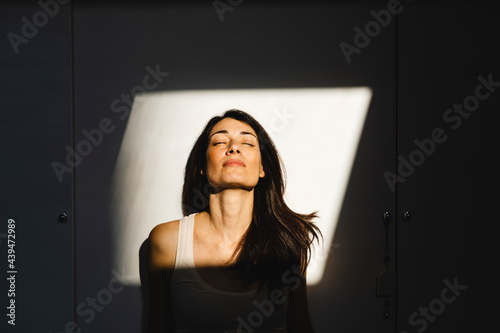 Portrait of a woman in a light window photo