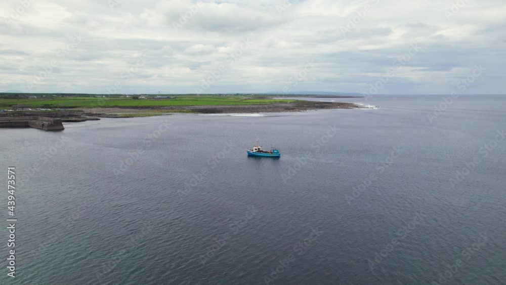 Aerial view of O'Dawd castle with approaching boat towards the marina. Aerial view of O'Dawd castle with approaching boat towards the marina.