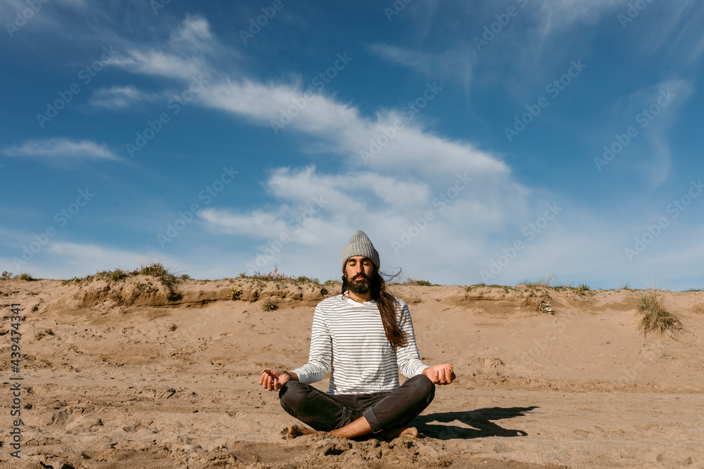 man practicing mindfulness sitting on the beach man practicing mindfulness sitting on the beach