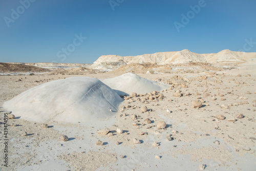 Beautiful lunar landscape. Wight and smooth hills in various shapes in a desert landscape. The whitish, rounded, winding, and smooth chalk rocks. Israel. High quality photo