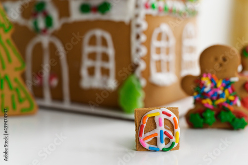 Gingerbread Peace Sign by a Decorated Gingerbread House photo