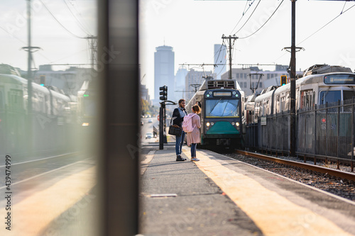 African American Couple arm in arm  in City while waiting for Train approaching 