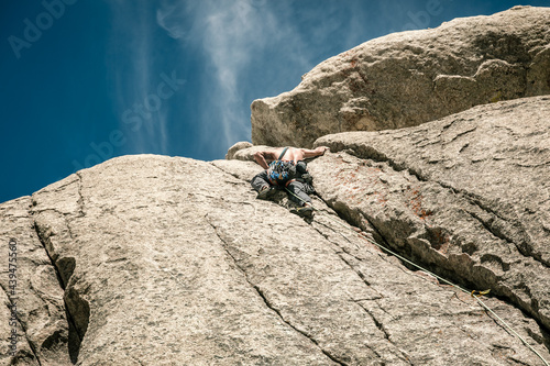 man climbing with camalots photo