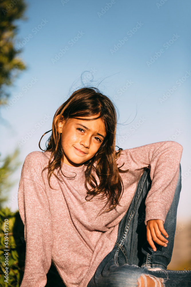 Portrait of cute girl posing in park at sunset Portrait of cute girl posing in park at sunset