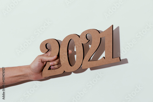 man with the number 2021 in his hand photo