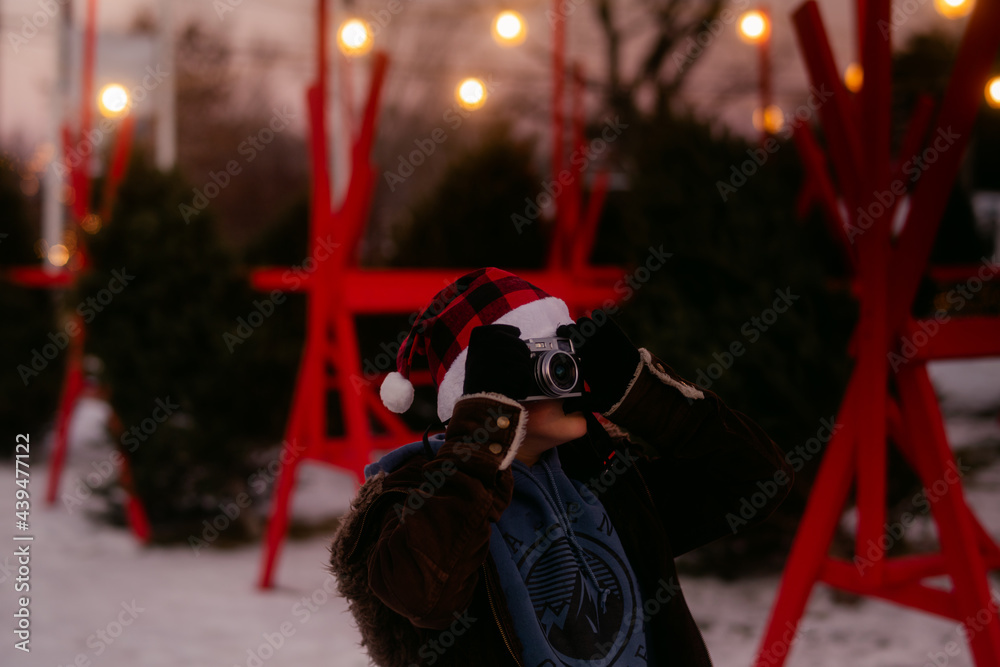boy with plaid Santa hat taking photos boy with plaid Santa hat taking photos