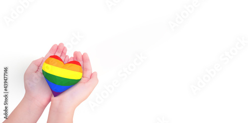 lgbtq rainbow heart on girl hands isolated white.Rainbow flag background.New LGBTQ+ Rights Pride Flag.Diverse diversity equality.Proud, give, protect design support and proud LGBTQ month.gay day.