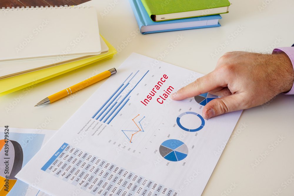Business concept meaning Insurance Claim with sign on the piece of paper. Business concept meaning Insurance Claim with sign on the piece of paper.