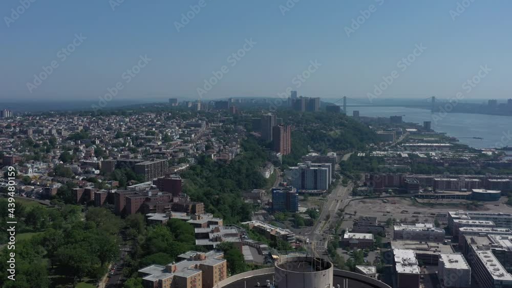 A drone view of North Bergen, NJ, looking northwest on a sunny day over a tall building. The camera pan left taking in the aerial views with the George Washington Bridge in the background. A drone view of North Bergen, NJ, looking northwest on a sunny day over a tall building. The camera pan left taking in the aerial views with the George Washington Bridge in the background.
