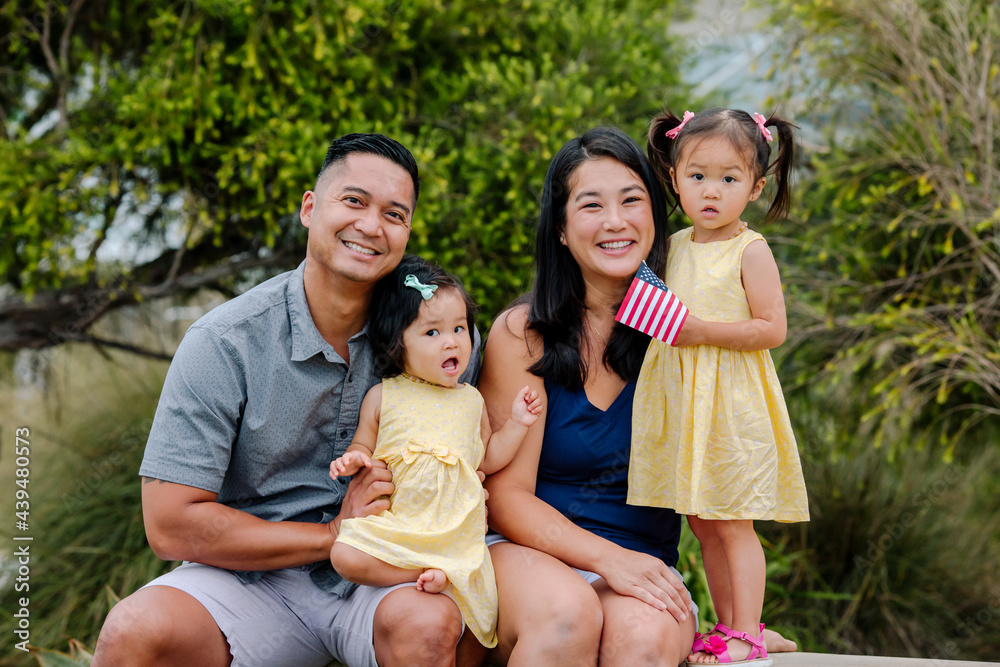 Happy Asian-American family with daughters outdoors Stock Photo | Adobe ...