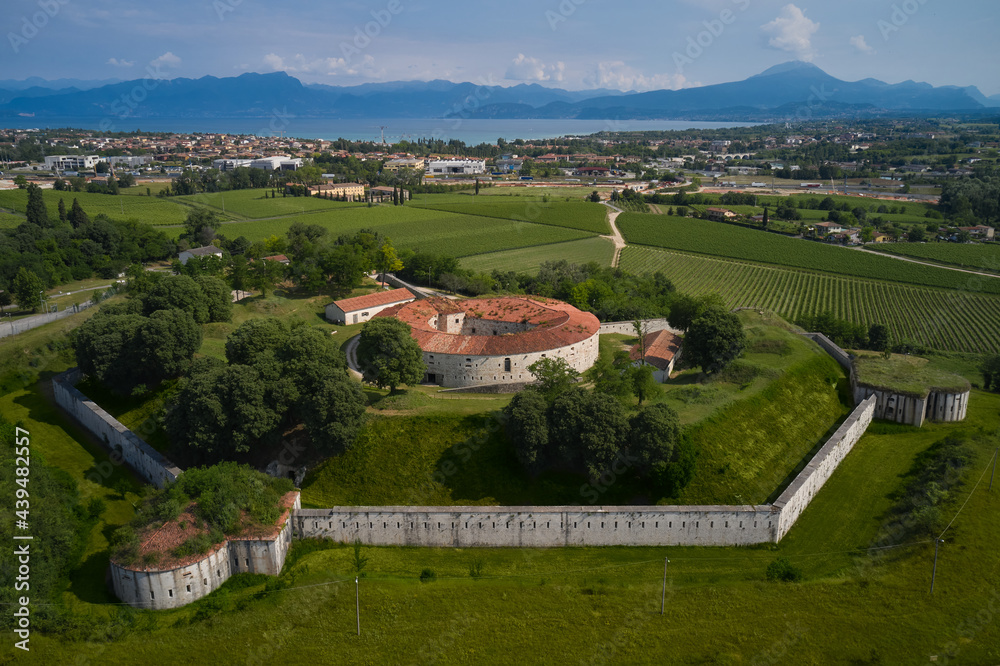 Fort Forte Ardietti on an elevated position overlooking Lake Garda, Italy. Austrian fort on the Italian territory of Peschiera del Garda. Aerial view of military historic fort.