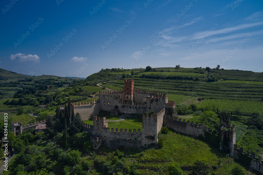 Soave castle aerial view, province of Verona, Italy. The famous medieval castle on the hill. Italian historic castles. Aerial panorama of Italy castles.