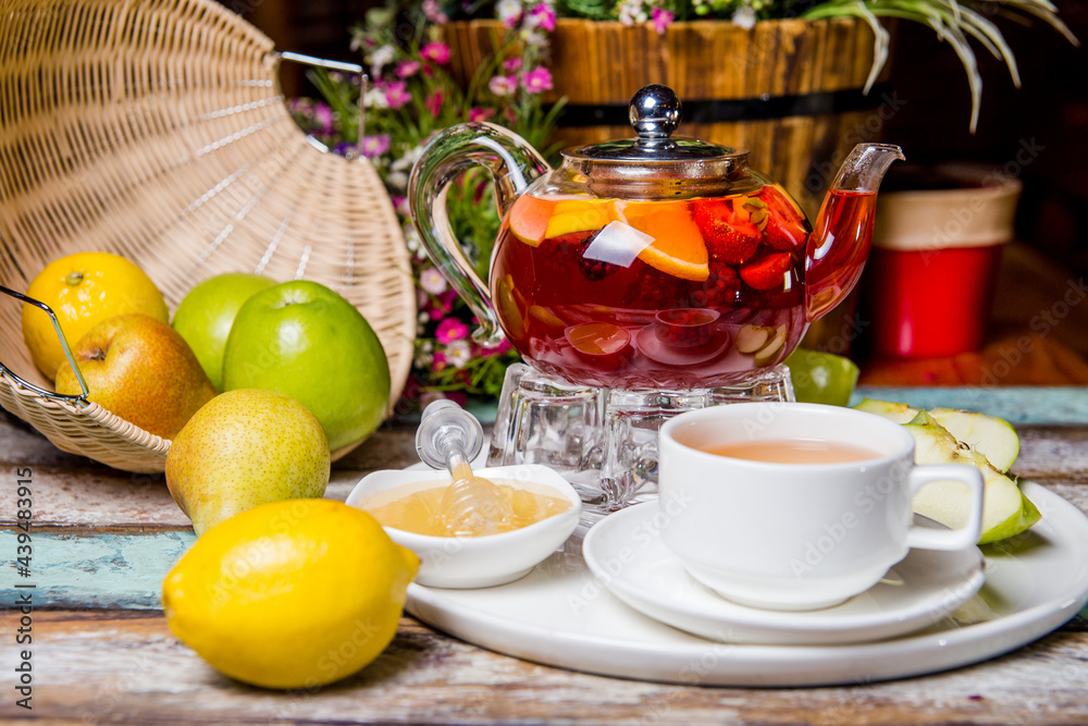 red fruit tea with pomegranate and white cup on the table red fruit tea with pomegranate and white cup on the table