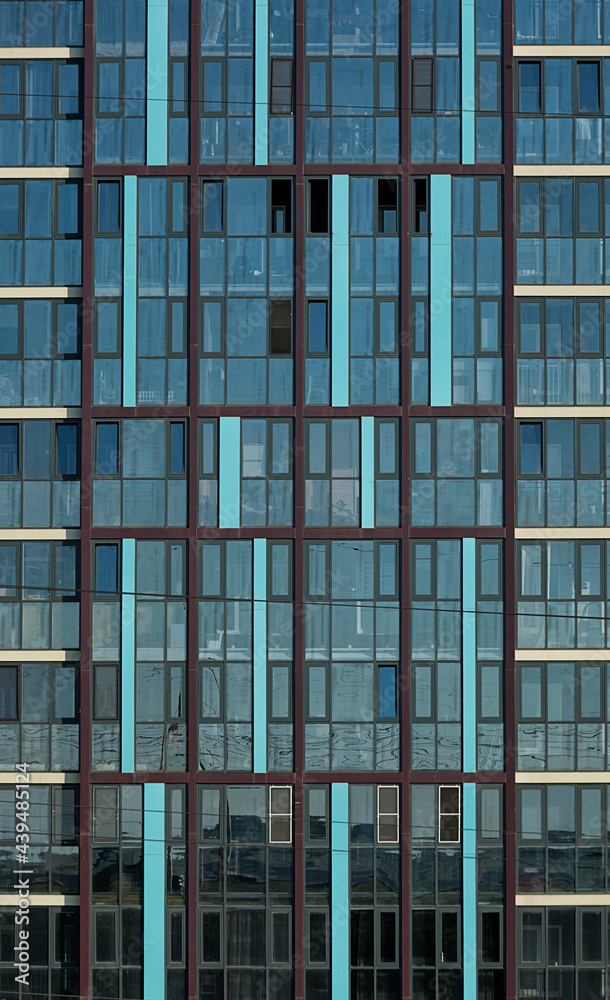 Obraz premium Facade of a multi-storey building, glazed wall, skyscraper windows