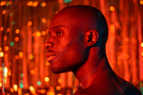 Profile Of A Black Man Under Red Light.  photo