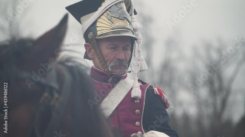 Portrait of a adult male hussar in medieval costume, soldier on horseback, the battle of Napoleon, close-up.