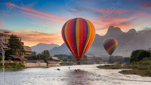 Nam Song river at sunset with hot air balloon in Vang Vieng, Laos, Beautifull landscape on the Nam Song River in Vang Vieng, Laos. photo