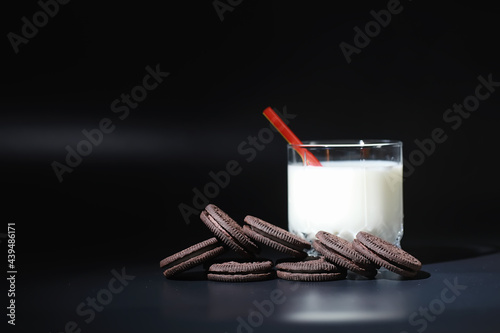 Milk drink in a glass. Farm milk and cookies. Delicious snack with cow's milk and fresh pastries.