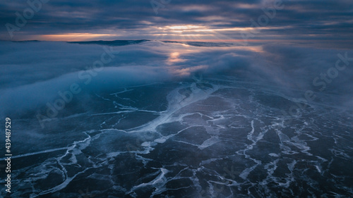 dramatic sunset above frozen river