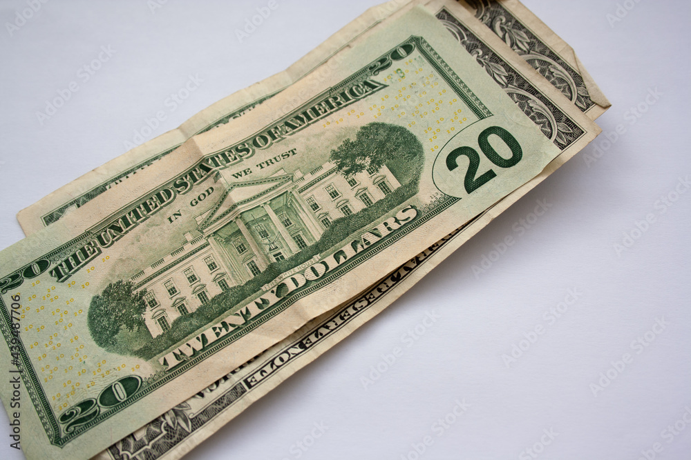 Wad of American dollar bills piled up on a white background. United States Twenty Dollar bill. Wad of American dollar bills piled up on a white background. United States Twenty Dollar bill.