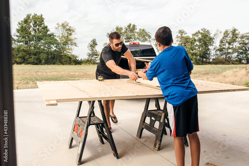 Wallpaper Mural Dad working on a woodworking project with the help of his son.  Torontodigital.ca