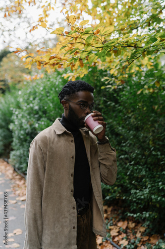 Student walking with Coffee Cup in the Park photo