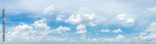 blue sky background with tiny clouds. panorama white fluffy clouds in the blue sky.Beautiful vast blue sky with amazing cloud background.Wide sky panorama with scattered cumulus clouds. © Chalermwoot
