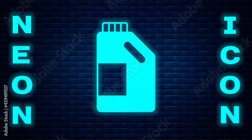Glowing neon Plastic bottle for laundry detergent, bleach, dishwashing liquid or another cleaning agent icon isolated on brick wall background. Vector