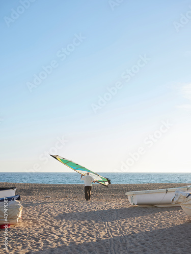 Aged man with windsurf sail photo